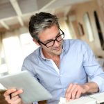 Handsome businessman with eyeglasses working from home